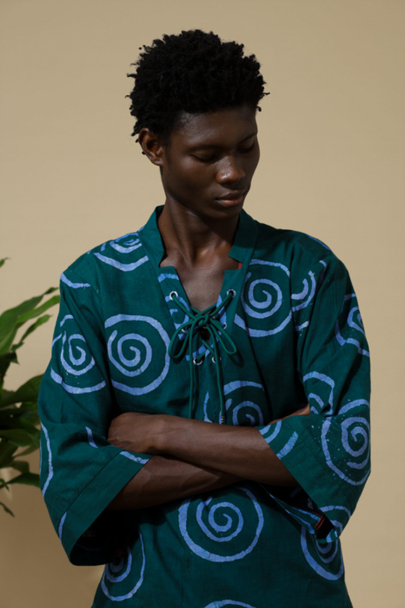 Male model wearing Cute Saint Irin-Ajo teal spiral batik lace-up top and matching harem pants