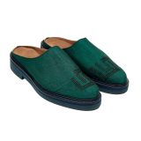 Angled view of Bata Mules in teal green textile featuring a black embroidered graphic logo on the toe
