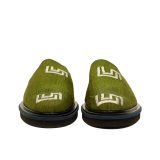 Front view of Bata Mules in olive green textile featuring two white graphic logos on the upper and brown leather lining.