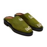 said view of Bata Mules in olive green textile featuring two white graphic logos on the upper and brown leather lining.