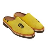 Angled view of Bata Mules in yellow textile with a black graphic logo on the side and a brown-and-tan layered sole.