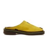 side view of Bata Mules in yellow textile with a black graphic logo on the side and a brown-and-tan layered sole.