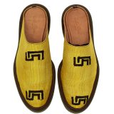 Top-down view of Bata Mules in vibrant yellow textile featuring two black graphic logos on the upper.